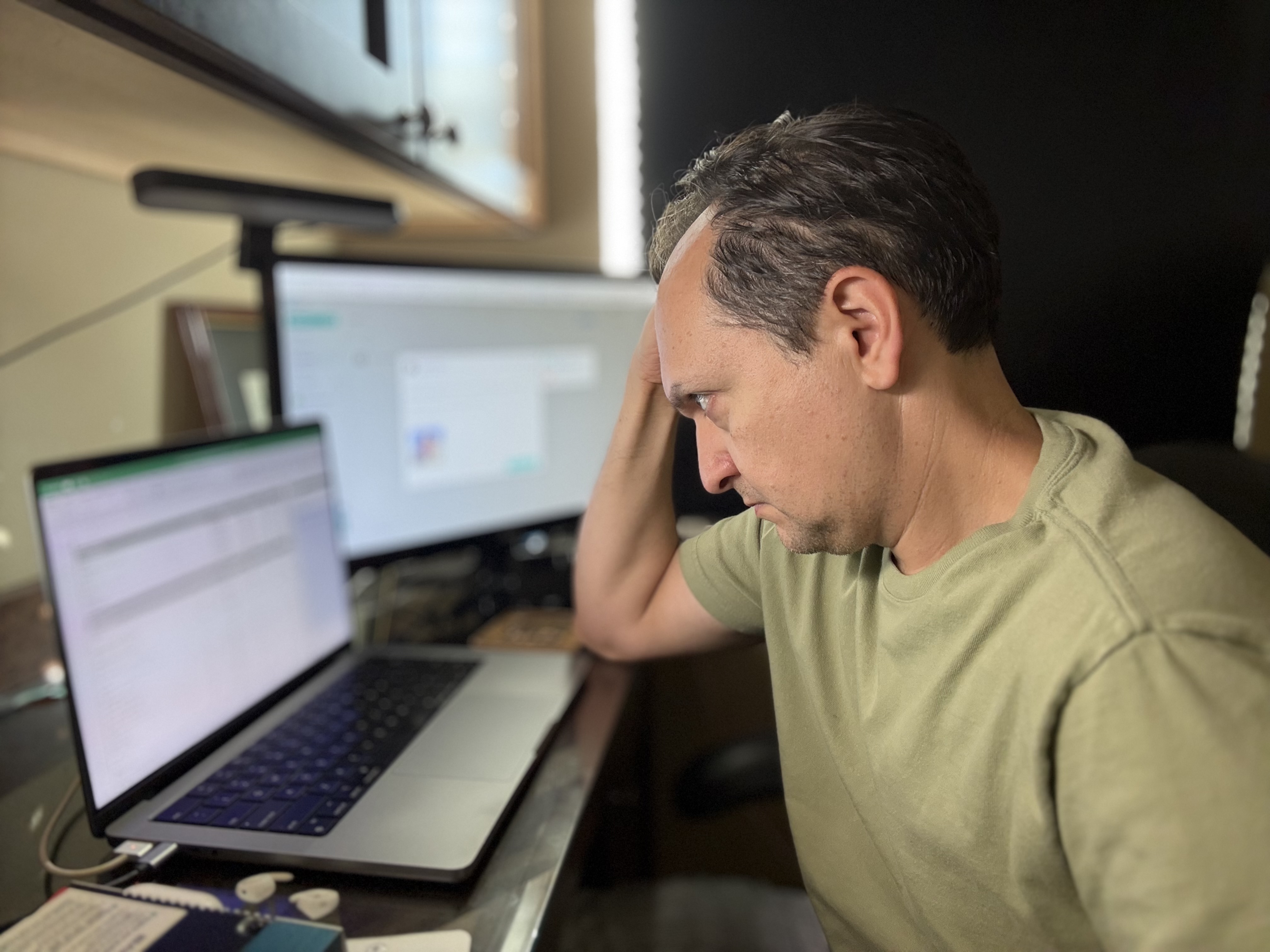 Eugene Gershman reviewing work at his desk